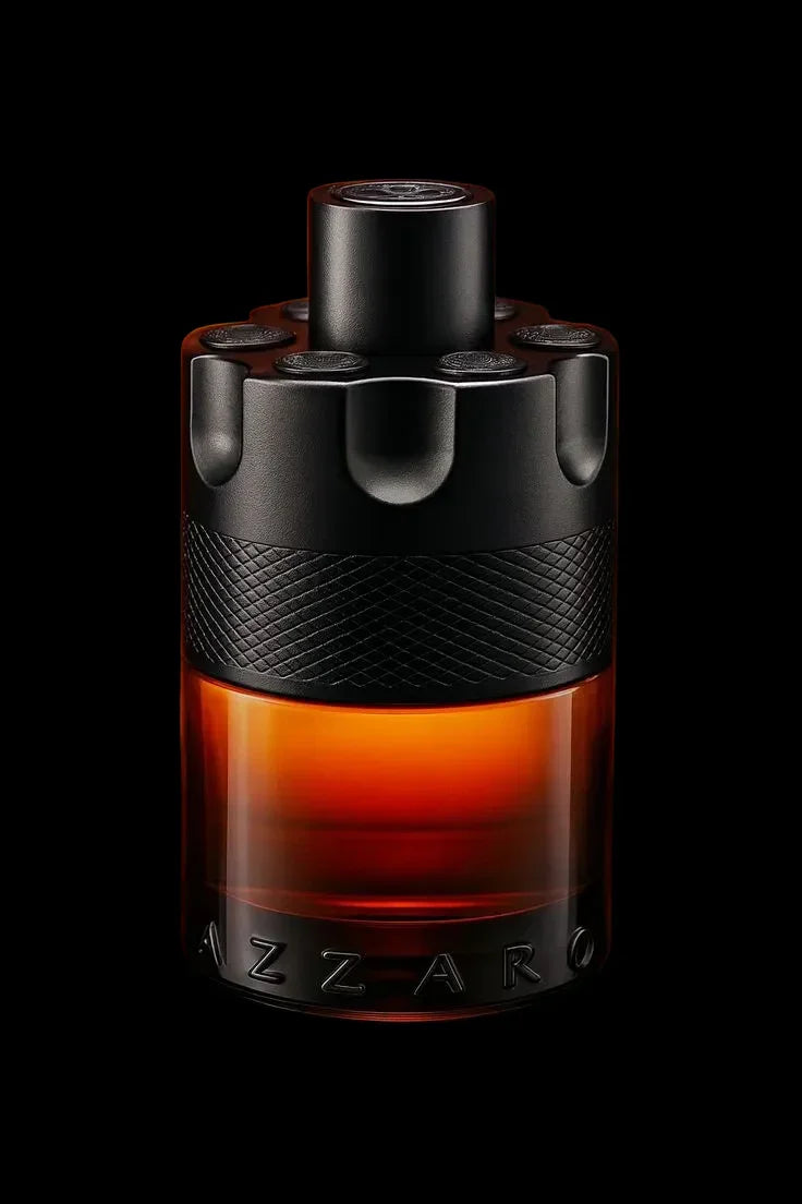 Elegant amber and black perfume bottle with textured cap and bold lettering on dark background