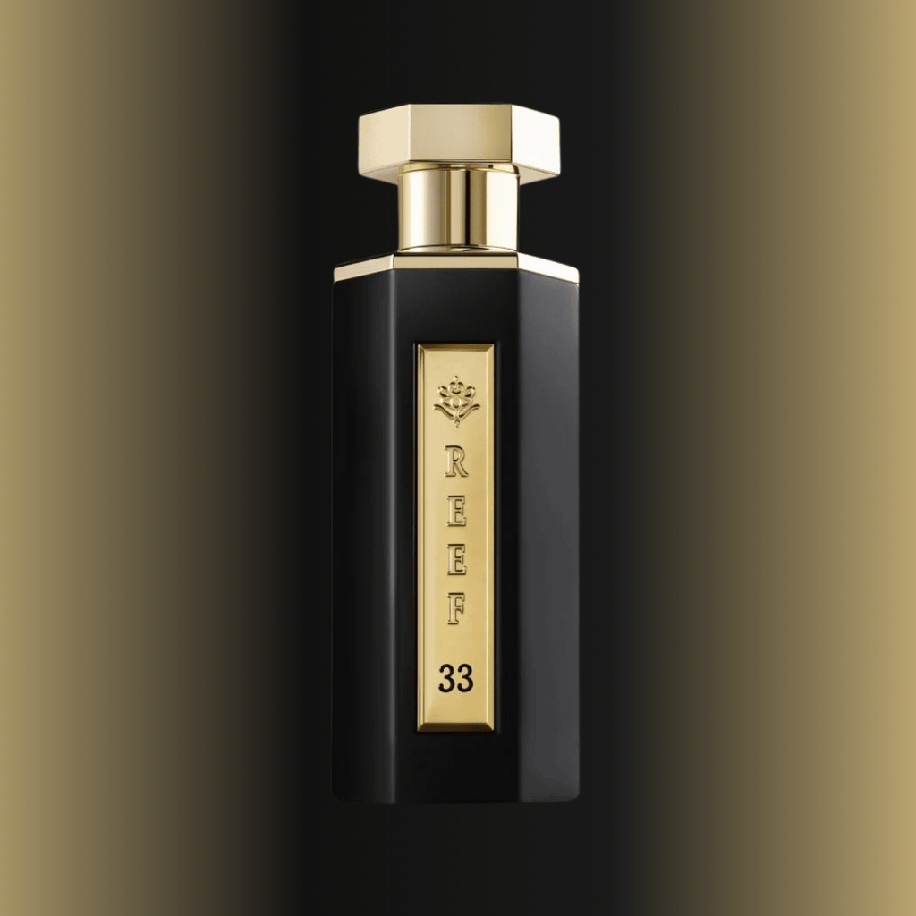Black and gold perfume bottle with 'REEF 33' branding on a gradient background