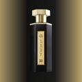 Black and gold perfume bottle with 'REEF 33' branding on a gradient background