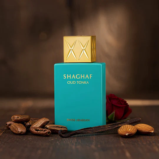 Shaghaf Oud Tonka perfume bottle with almonds and a rose on a wooden surface
