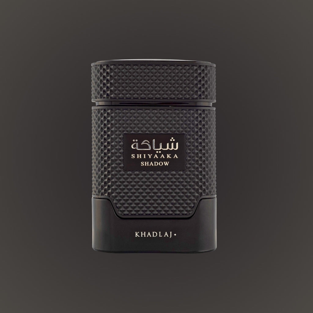 Black textured perfume bottle with 'Shiyaaaka Shadow' and 'Khadlaj' branding on a dark background