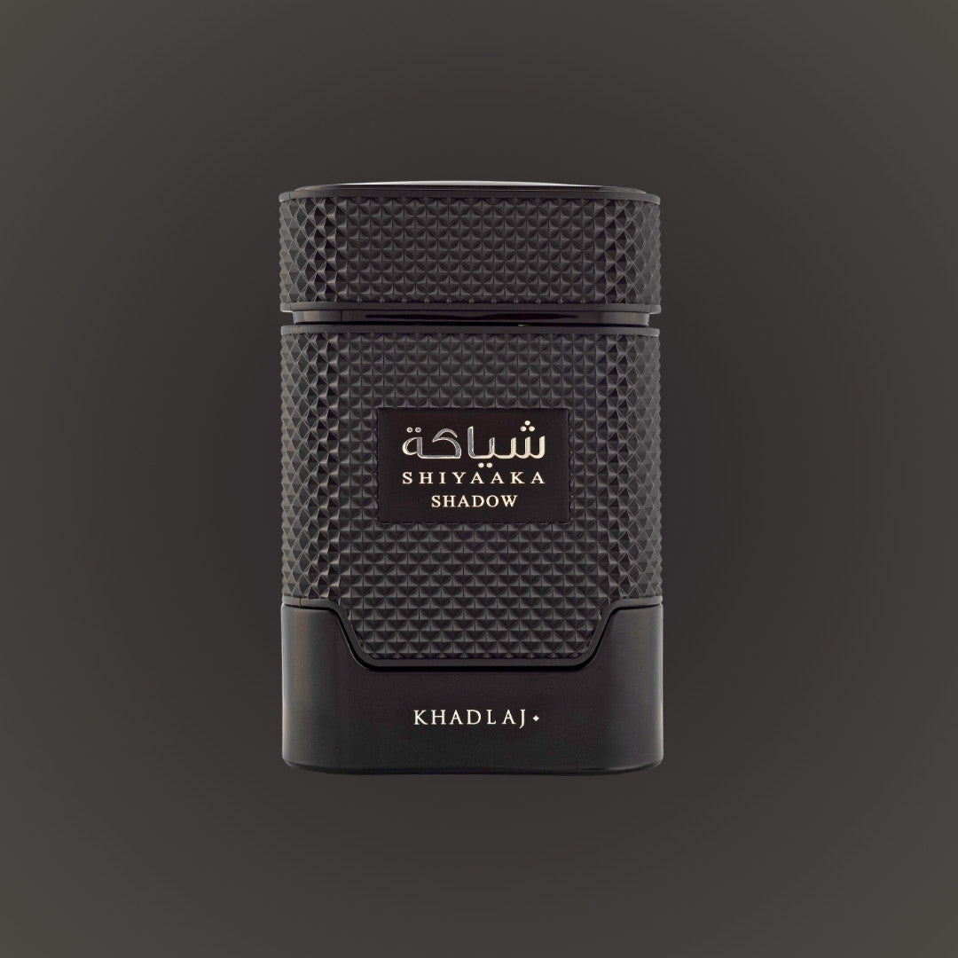 Black textured perfume bottle with 'Shiyaaaka Shadow' and 'Khadlaj' branding on a dark background