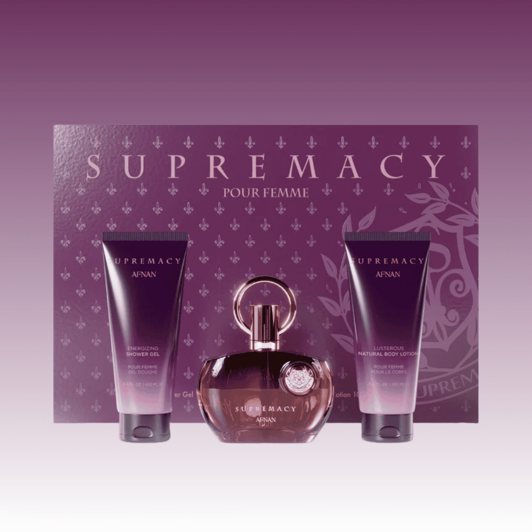 Supremacy pour Femme perfume set with bottle and two tubes each containing shower gel and body lotion against a purple background 