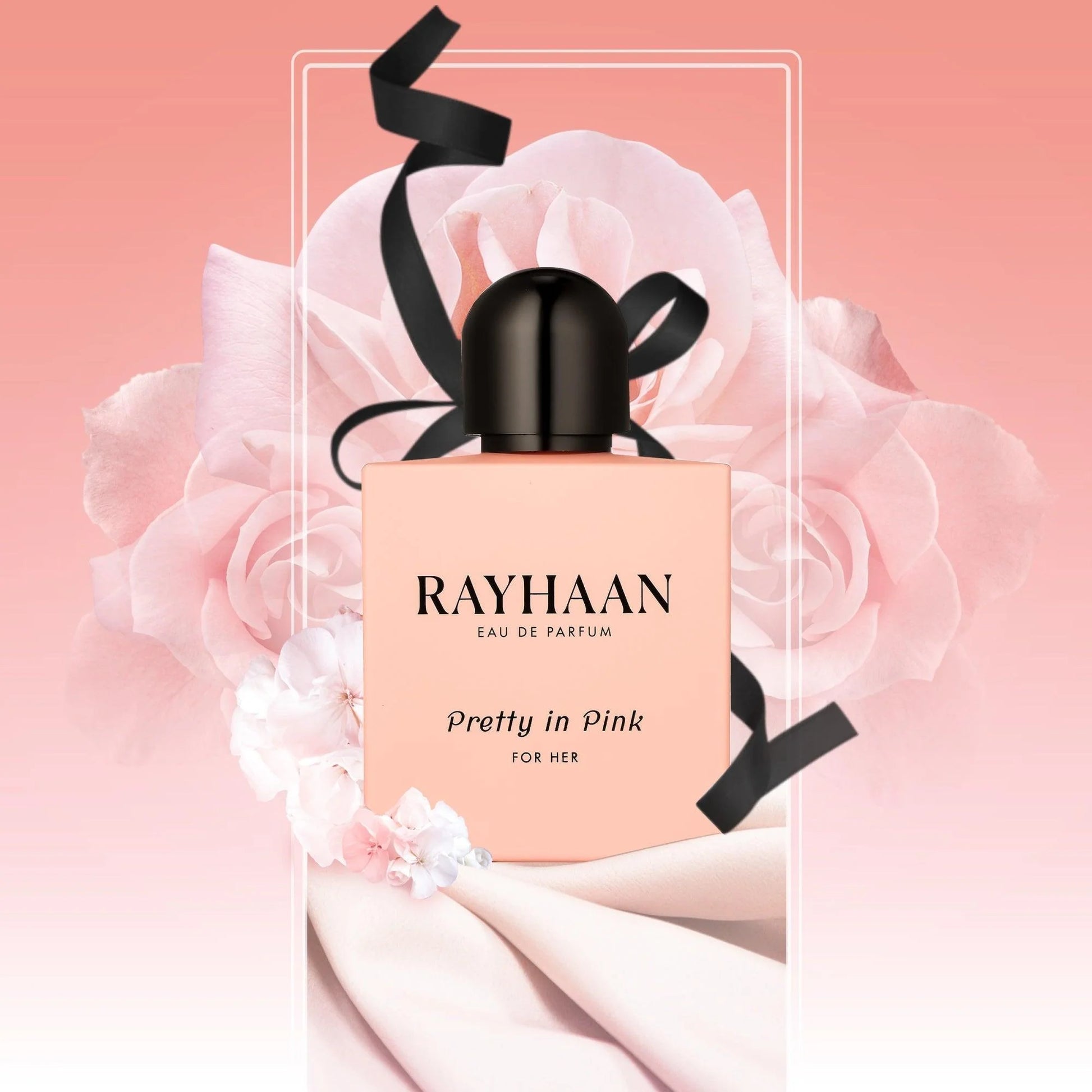 RAYHAAN perfume bottle with pink packaging and black ribbon on a pink floral background